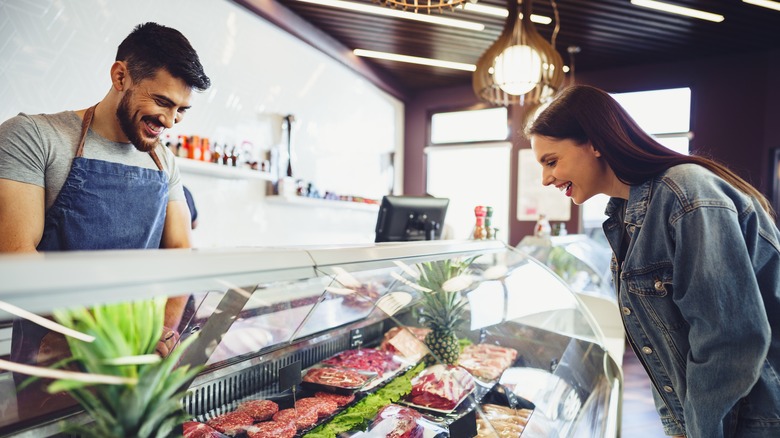 Butcher and customer at counter