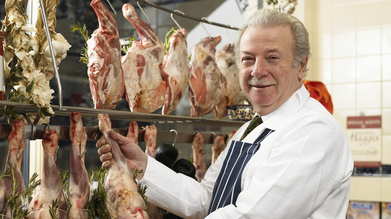 Butcher holding leg of lamb