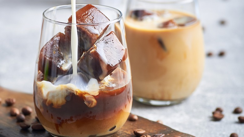 Pouring milk on coffee ice cubes