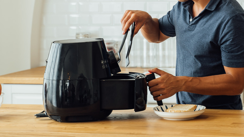 man using an air fryer