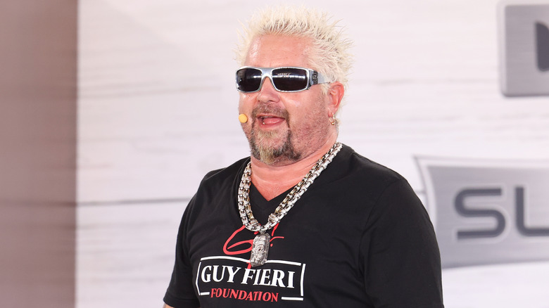 Guy Fieri with a silver chain necklace