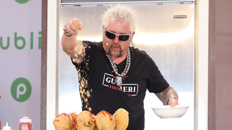 Guy Fieri wearing black glasses