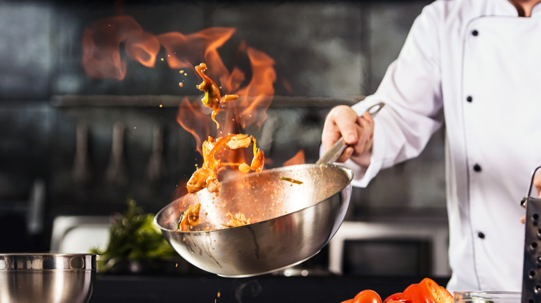 Flaming wok and white coat