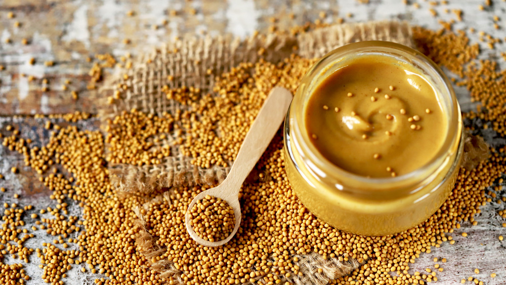 Jar of mustard with mustard seeds