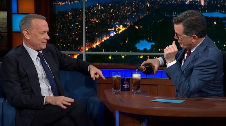 Tom Hanks and Stephen Colbert pouring drinks on The Late Show.