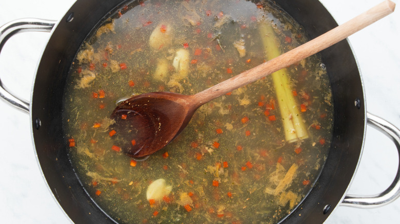 chicken broth and spices in pot 