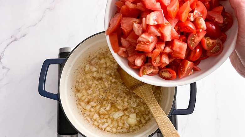 add tomatoes to pot onions