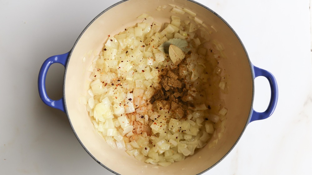 onions, garlic and spices in dutch oven