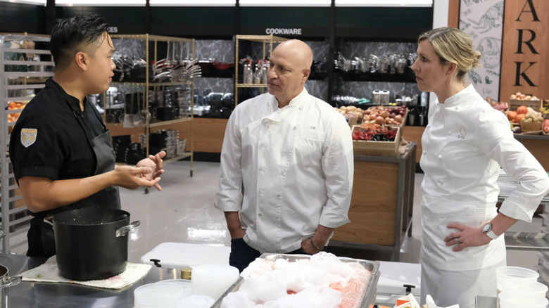 Buddha Lo, Tom Colicchio, and Clare Smyth talking in kitchen