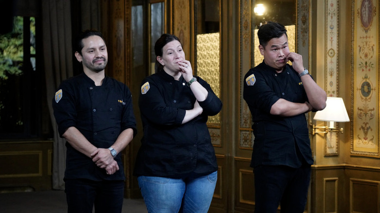 Gabriel Rodriguez, Sara Bradley, and Buddha Lo waiting with chef coats