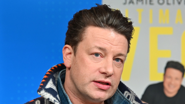 Jamie Oliver speaking while  looking serious 