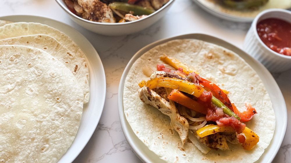 Grilled chicken fajitas on flour tortillas