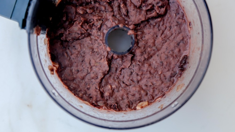 Refried beans being mixed for tostadas