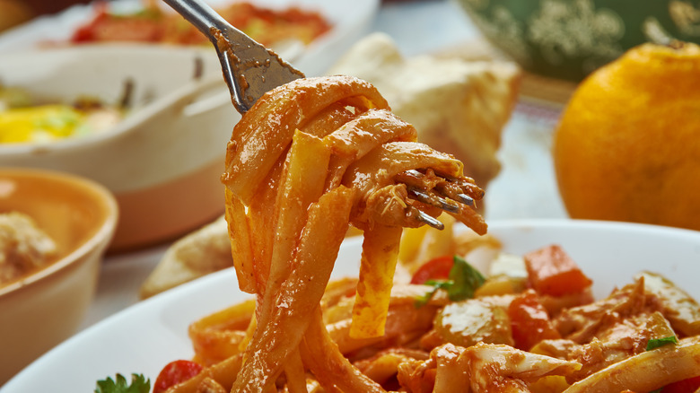 taking a bite of Cajun-style fettuccini alfredo