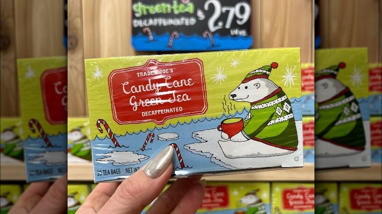 Someone holding up a box of Trader Joe's candy candy green tea