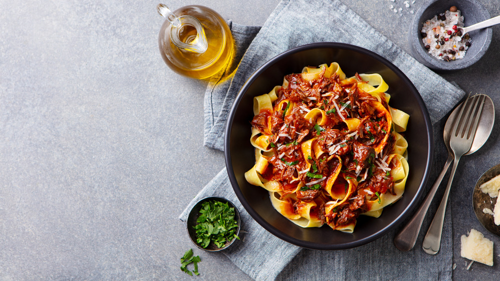 Pasta with Bolognese sauce in a black bowl