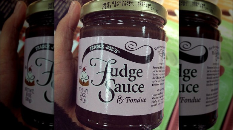 Holding  Trader Joe's Fudge Sauce 