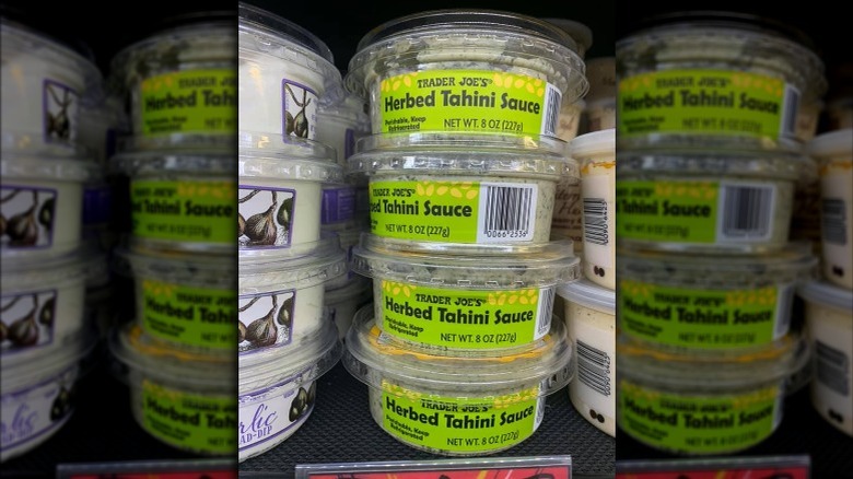 Several containers of herbed tahini sauce from Trader Joe's