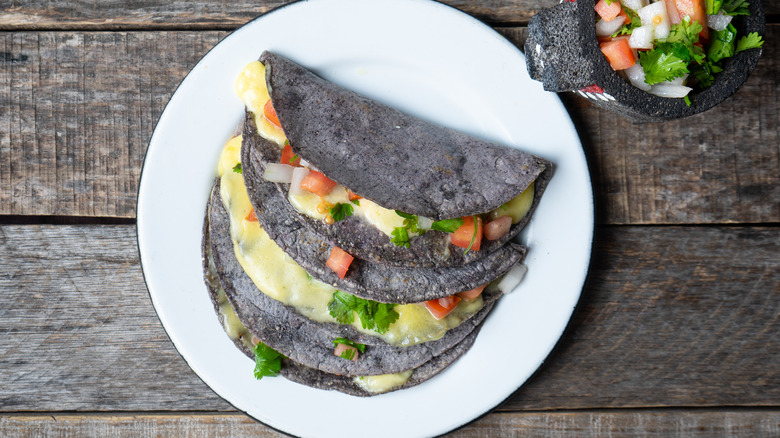 Blue corn tacos on wooden table 