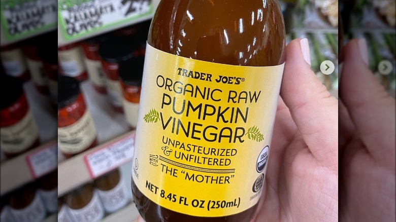 Hand holding bottle of Trader Joe's pumpkin vinegar