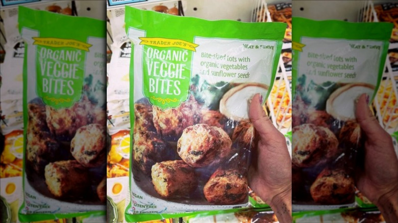 Hand holding package of Trader Joe's frozen Organic Veggie Bites