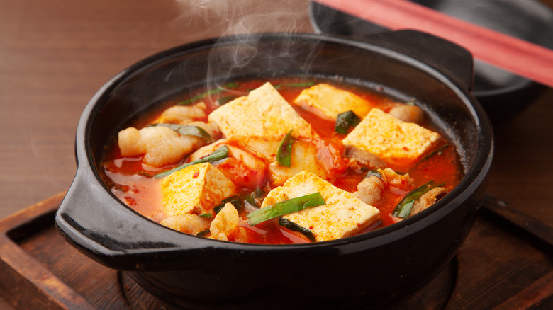 Tofu and Kimchi soup in a black pot