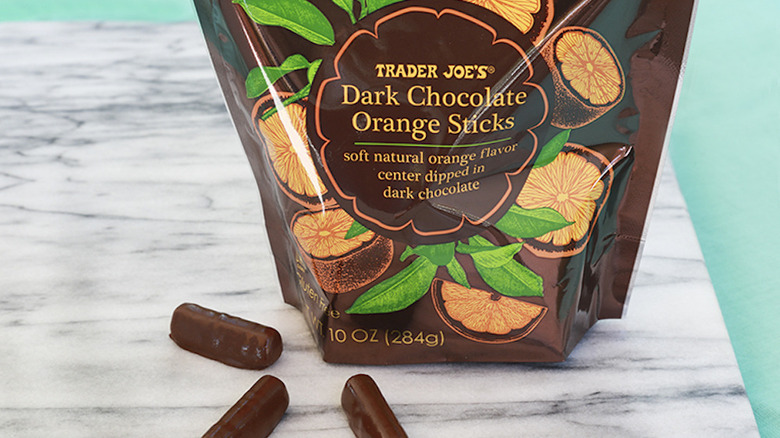 Bag of Dark Chocolate Orange Sticks with some loose on countertop