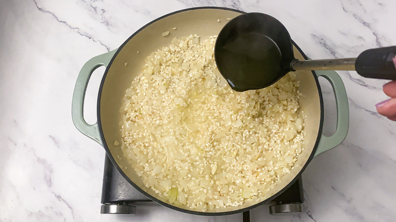 Pan of rice with ladle of broth