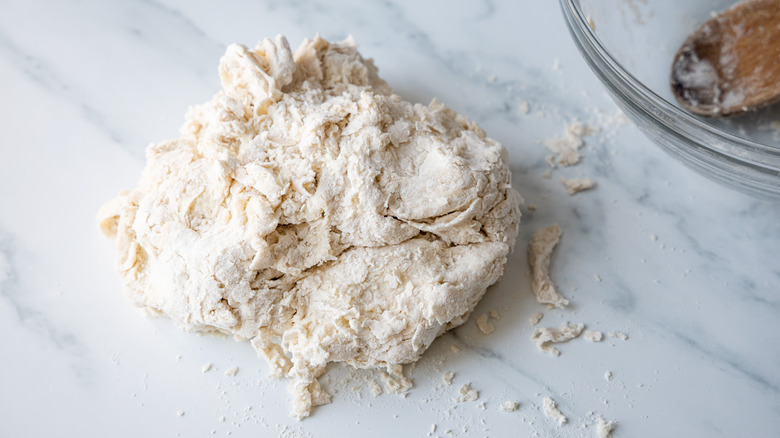 sticky German brotchen dough being mixed on counter