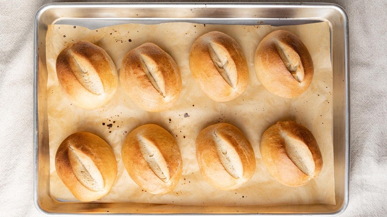 Baked Traditional German Brotchen bread rolls on parchment-lined baking sheet