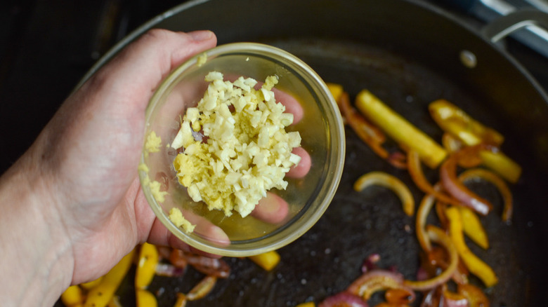 adding minced garlic and ginger