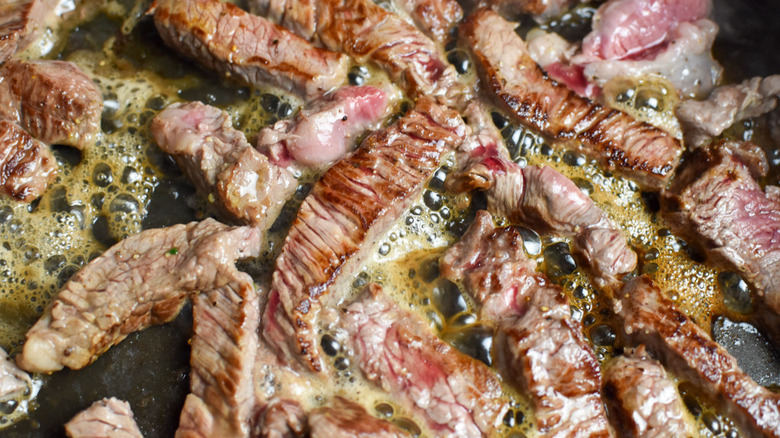 beef cooking in a pan