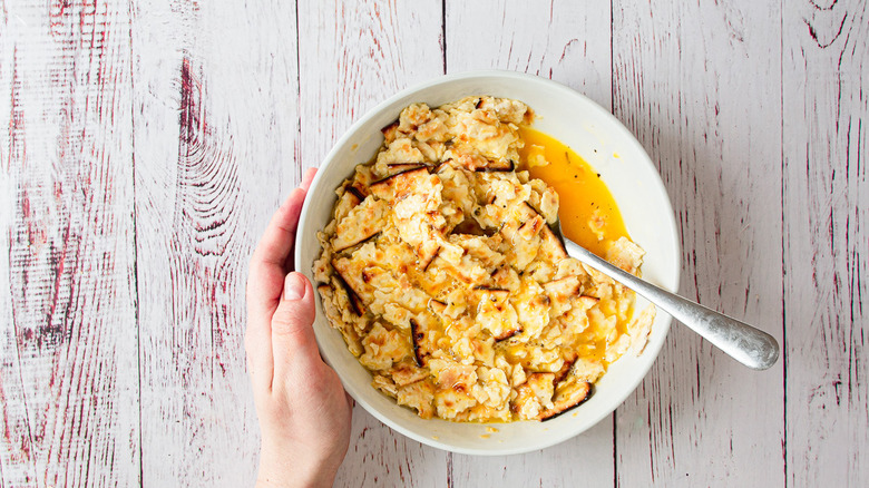 hand holding bowl of matzo