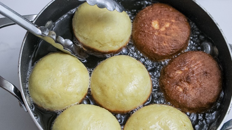 doughnuts frying in oil