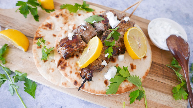 Pork souvlaki on pita with tzatziki and lemon