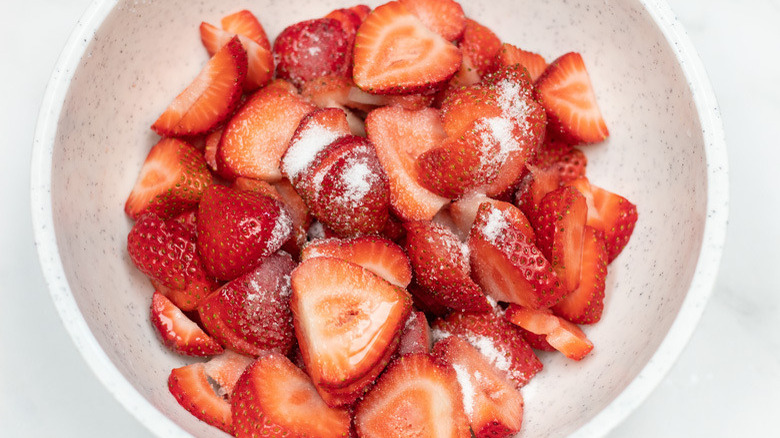 Bowl of sliced strawberries with sugar