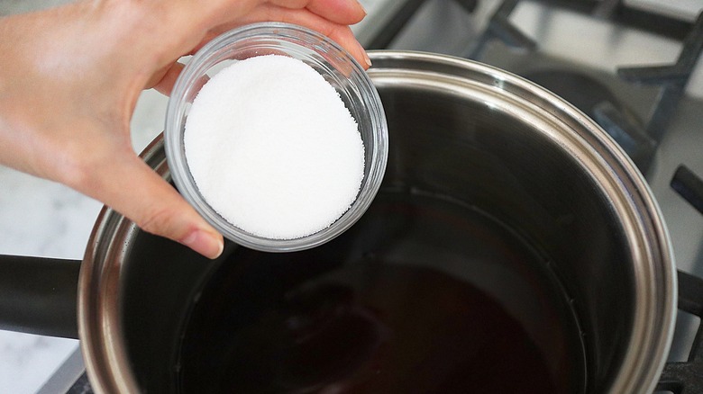 pouring sugar into pot