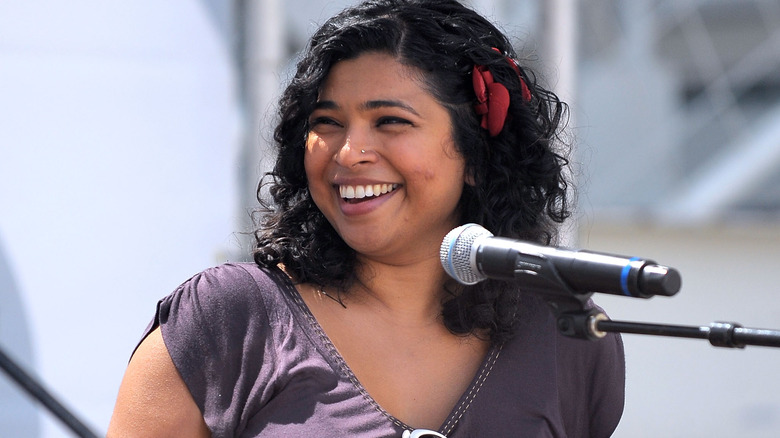 Aarti Sequeira behind a mic