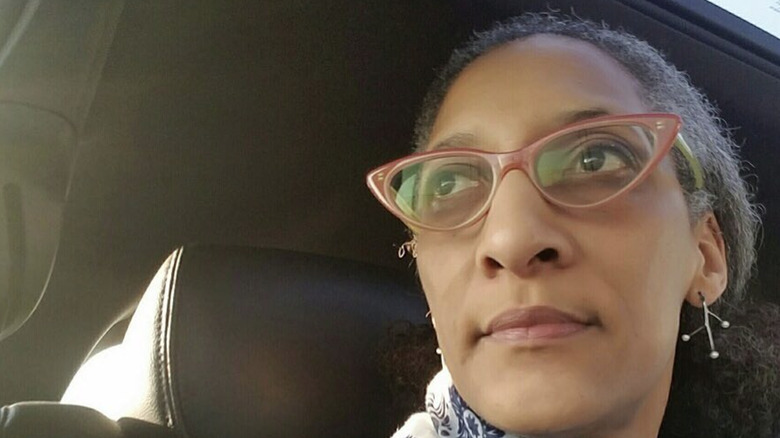 Carla Hall looking into distance inside car