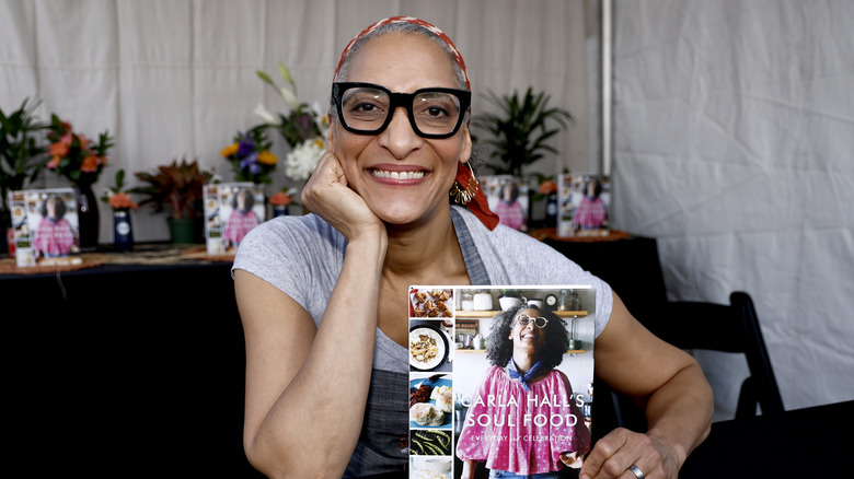 Carla Hall holds her Soul Food cookbook