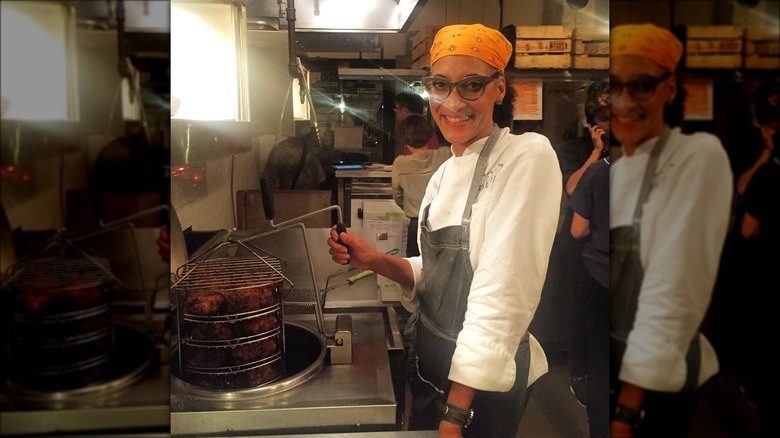 Carla Hall frying chicken in commercial kitchen