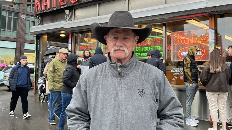 Kent Rollins stands on NYC street