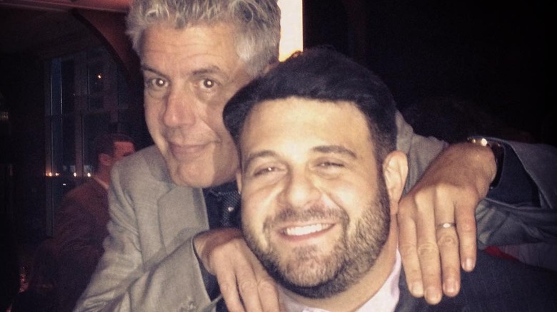 Anthony Bourdain massaging Adam Richman