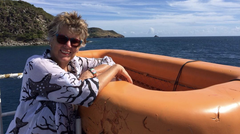 Prue Leith poses with orange raft at sea