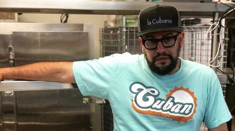 Carl Ruiz posing in a La Cubana baseball cap