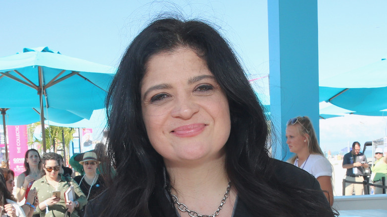 Alex Guarnaschelli with blue umbrellas in background