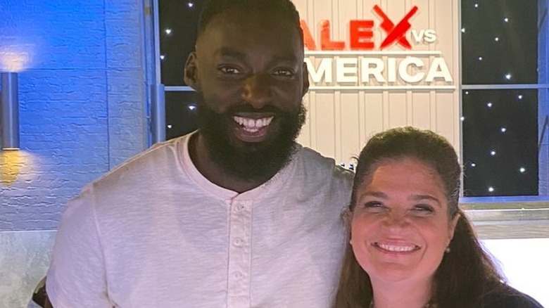 Eric Adjepong and Alex Guarnaschelli pose in TV studio