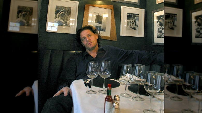 Marco Pierre White poses in restaurant booth