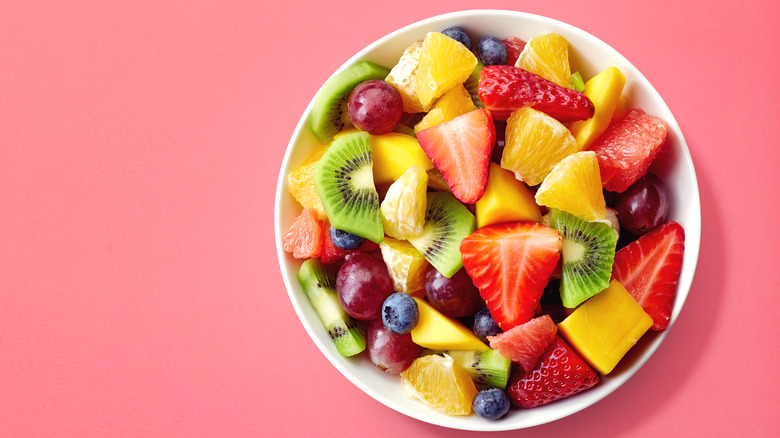 Fruit salad on a pink background