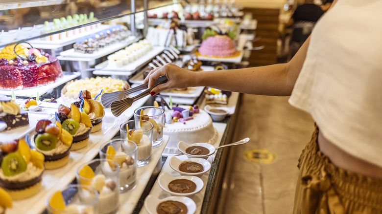 person serving from dessert buffet